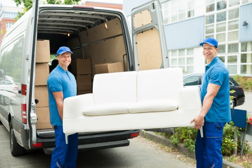 Furniture pick-up team collecting a sofa from a Hampstead home