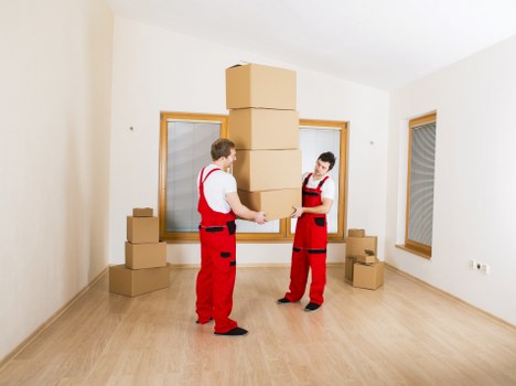 Local movers handling furniture in a Hampstead residential street